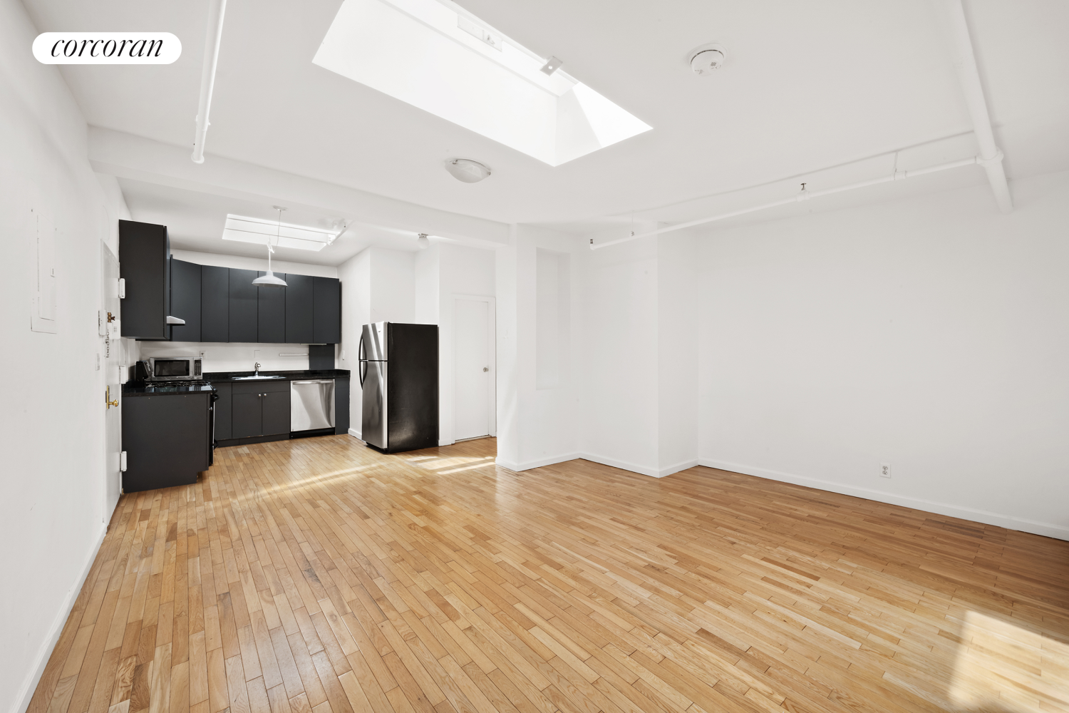 a view of kitchen with cabinets