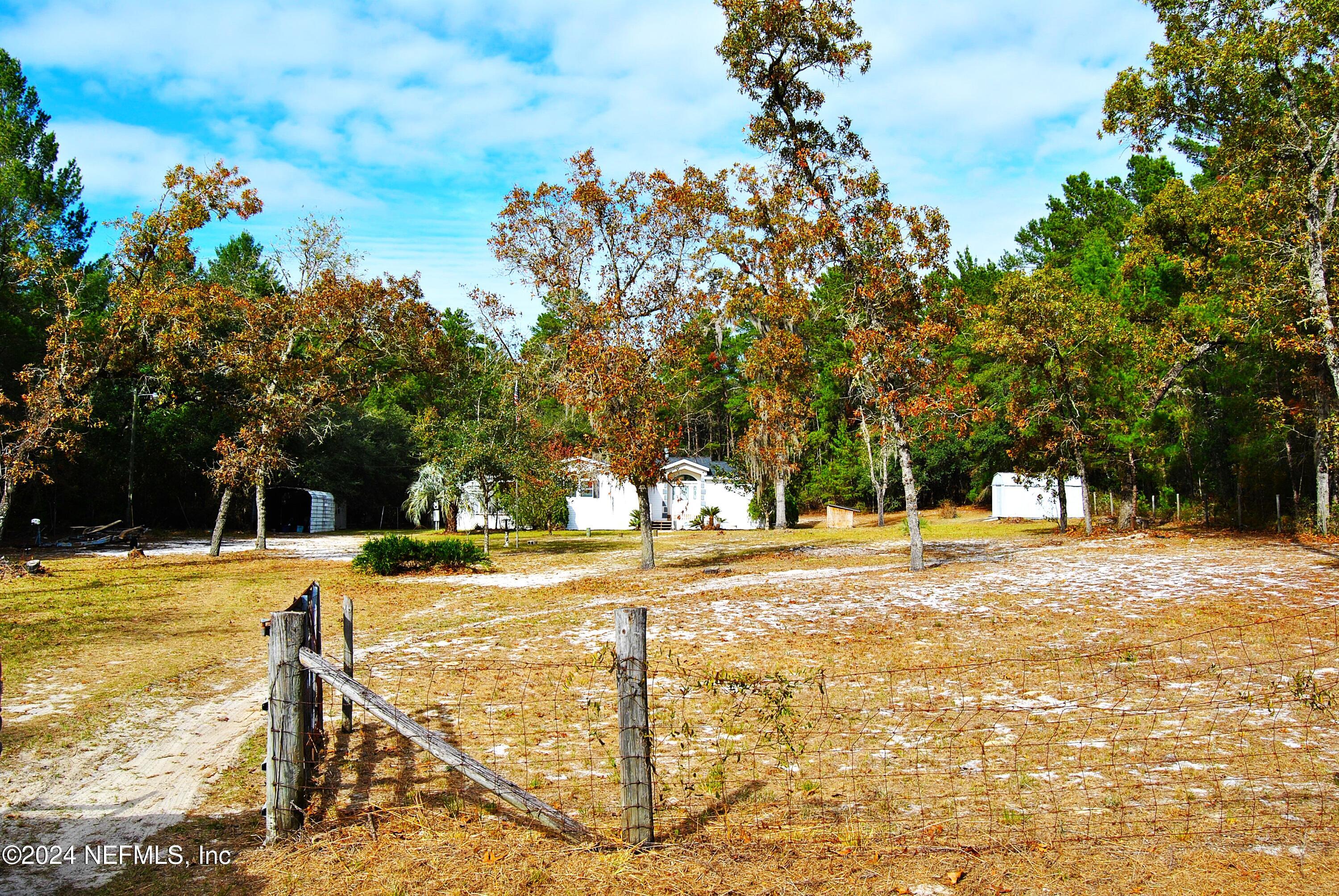 a view of a yard with swimming pool