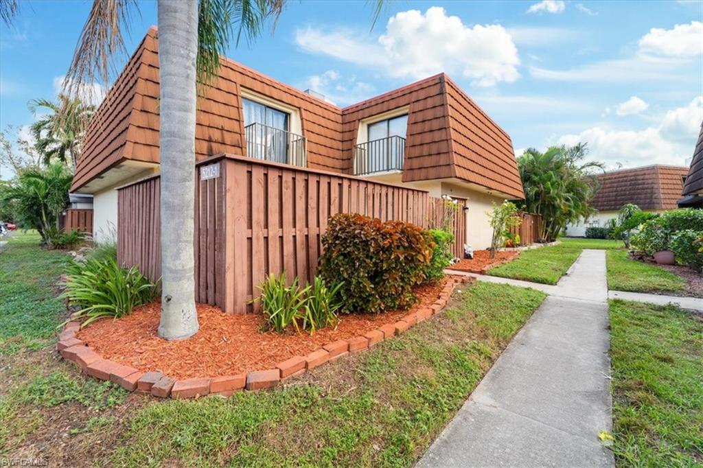 View of property exterior with a yard