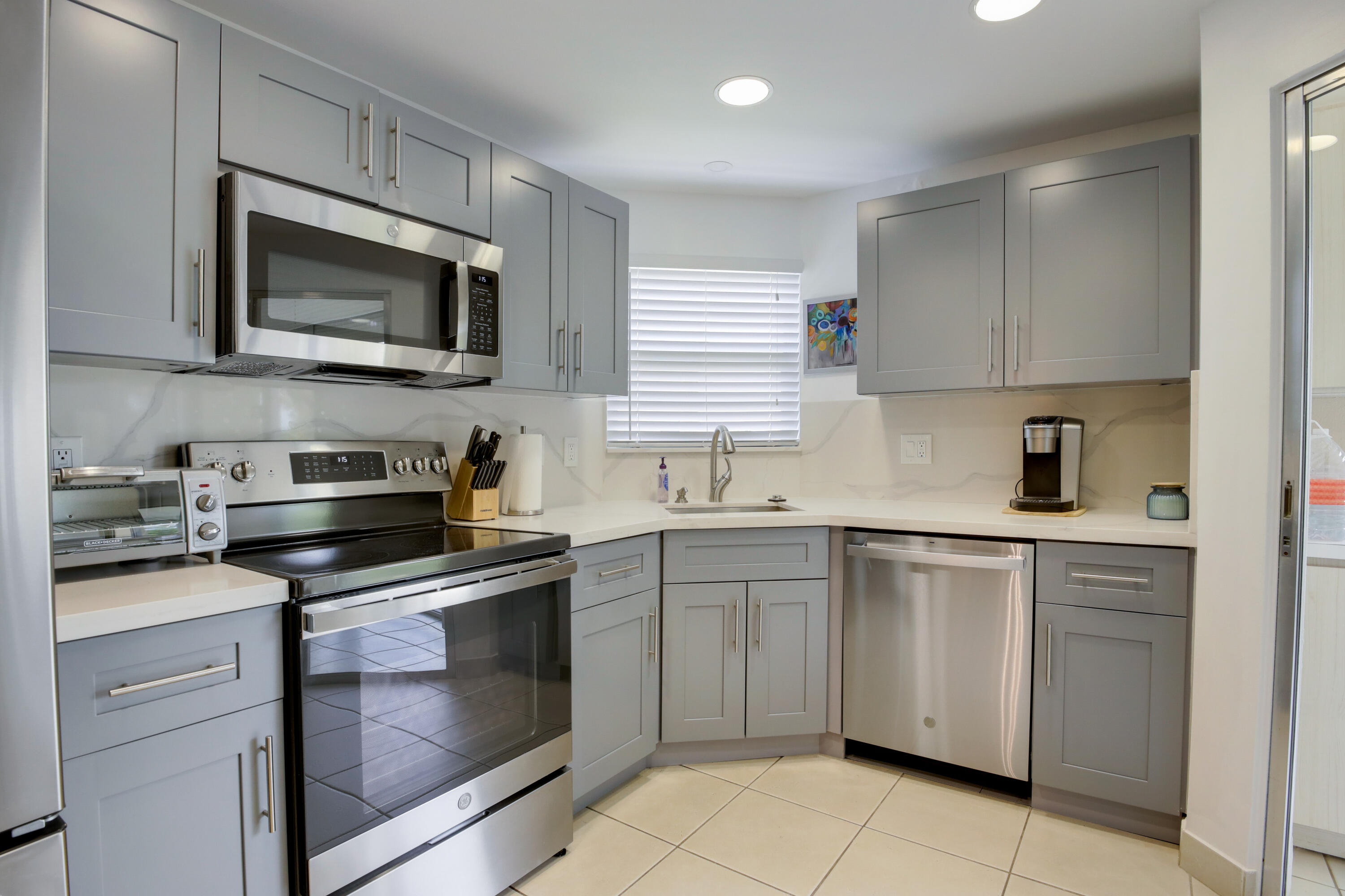 a kitchen with cabinets stainless steel appliances and a sink