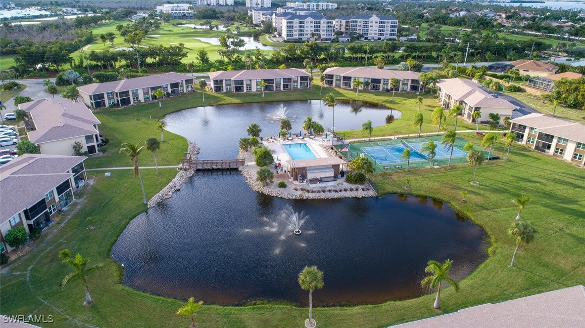 a aerial view of a house with swimming pool and lake view