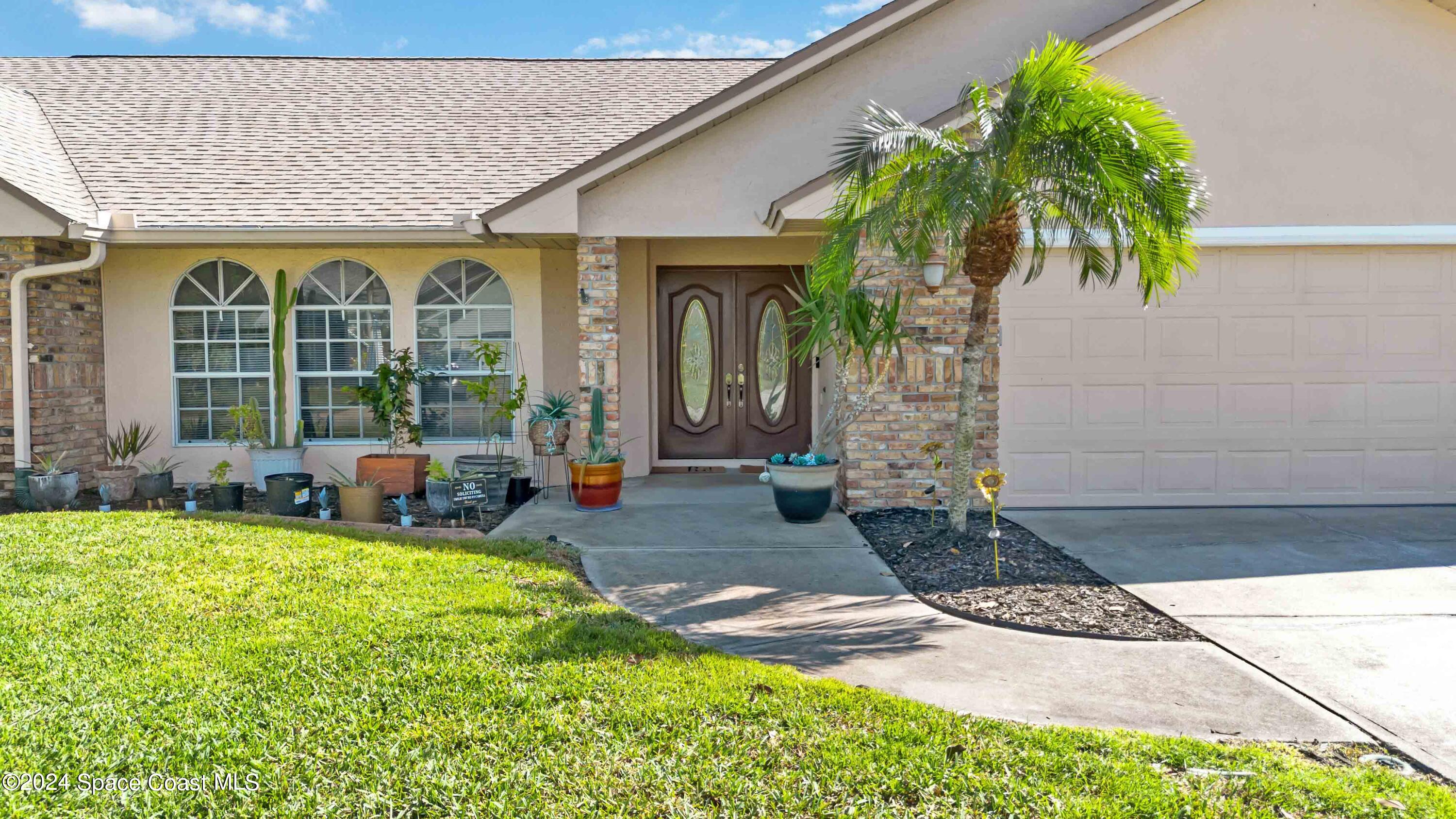 a front view of a house with garden