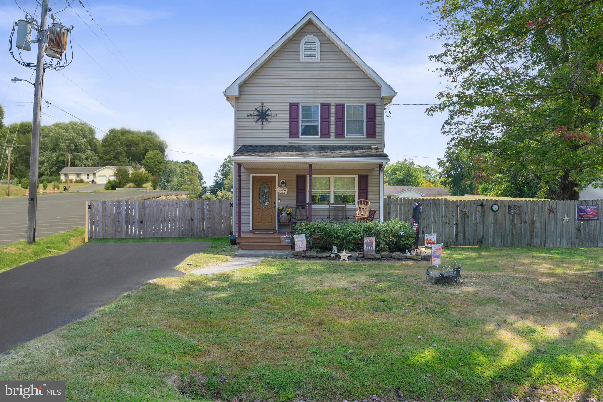 a view of a house with backyard and a tree