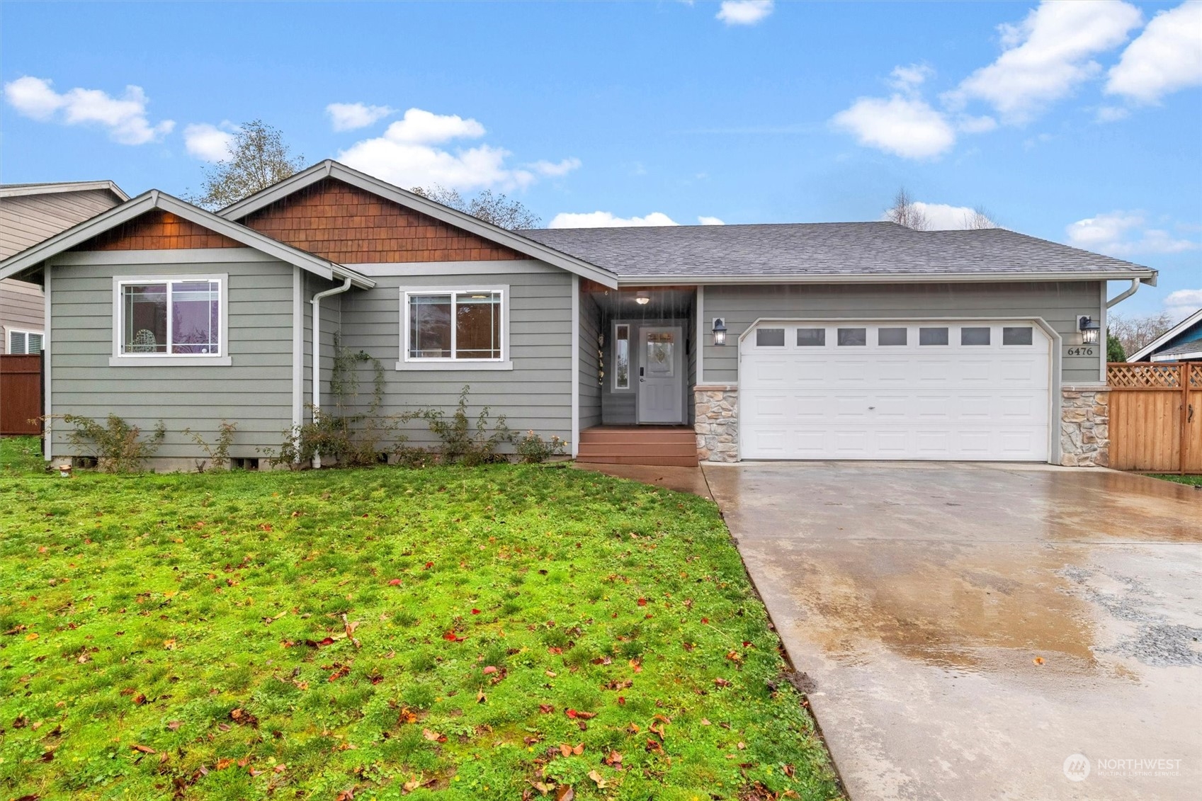 a view of front of house with a yard and garage