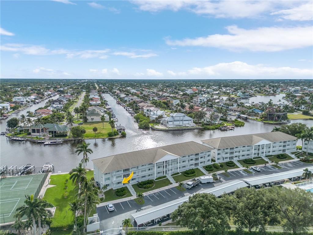 an aerial view of residential houses with outdoor space and lake view