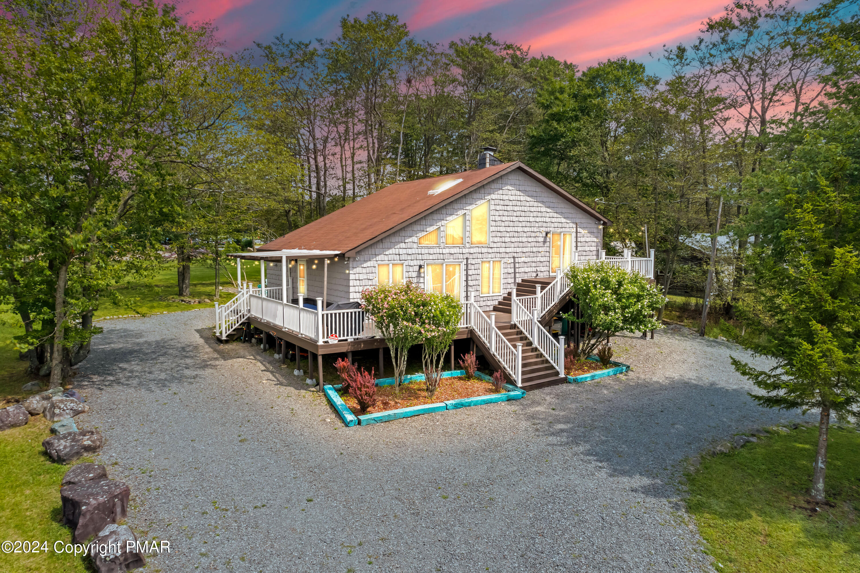 a view of a house with a yard and sitting area