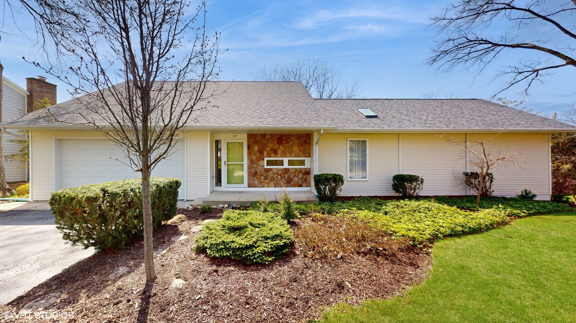 a front view of a house with garden