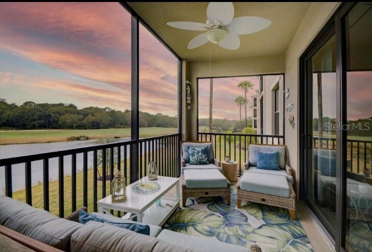 a balcony with furniture and a potted plant