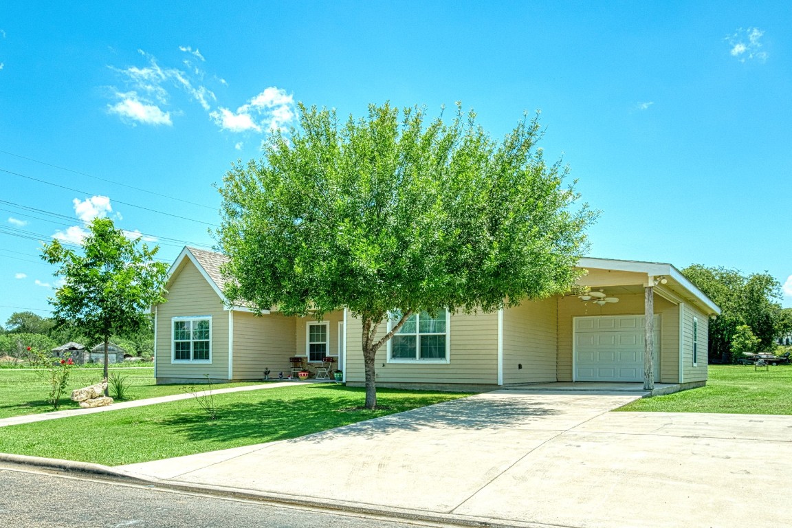 a front view of a house with a yard and a garage