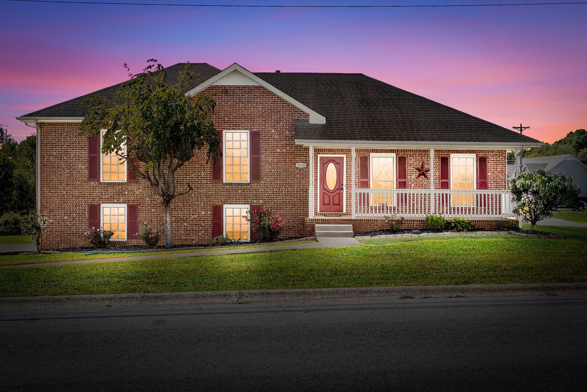 a front view of a house with a garden