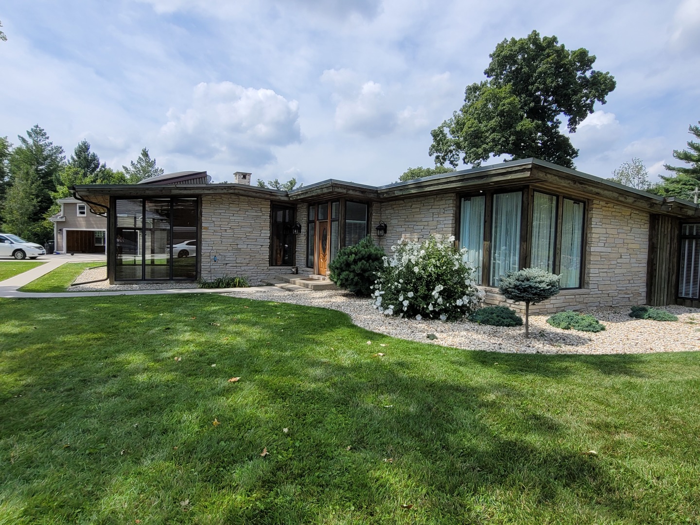 a view of a house with backyard and sitting area