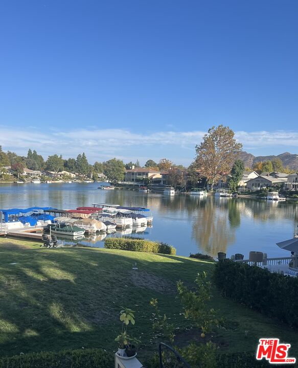 a view of a lake with houses in the back