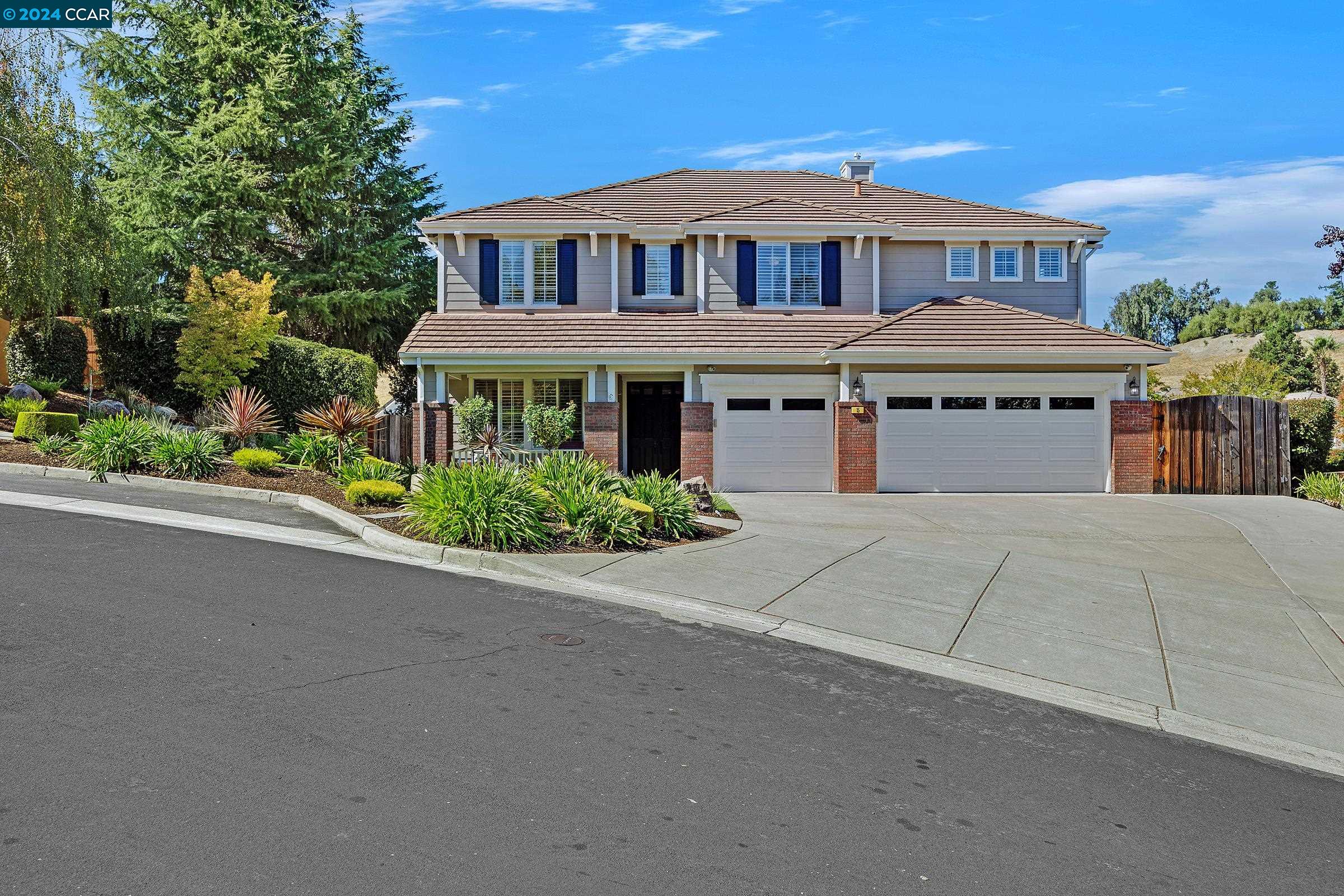 a front view of a house with a garden