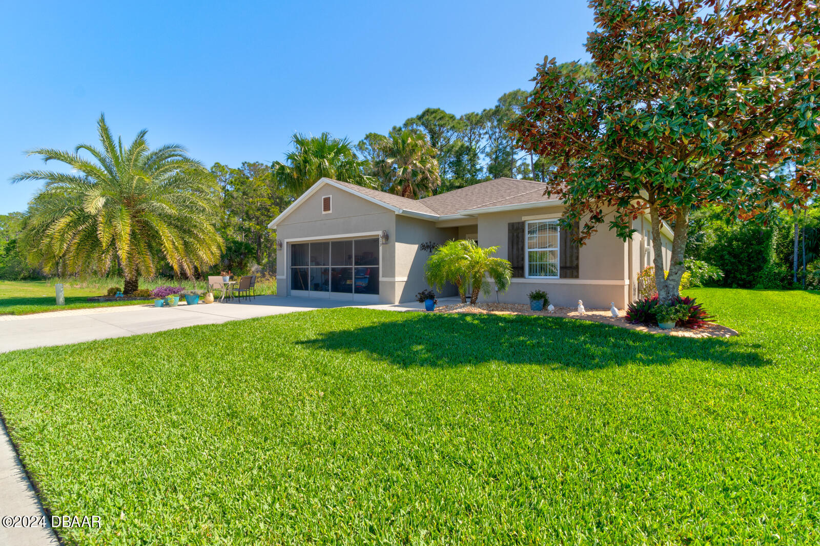 a front view of house with yard and green space