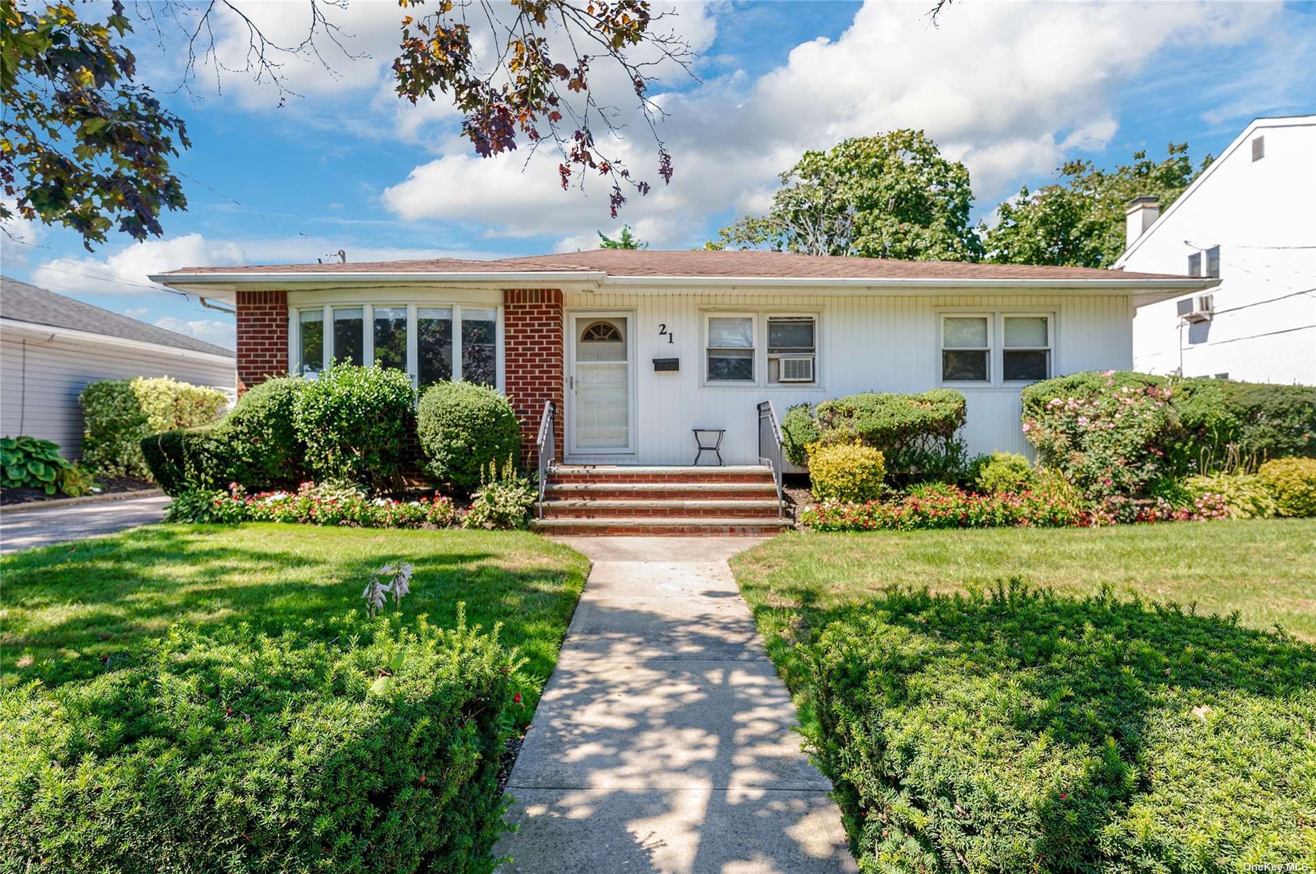 a front view of house with yard and green space