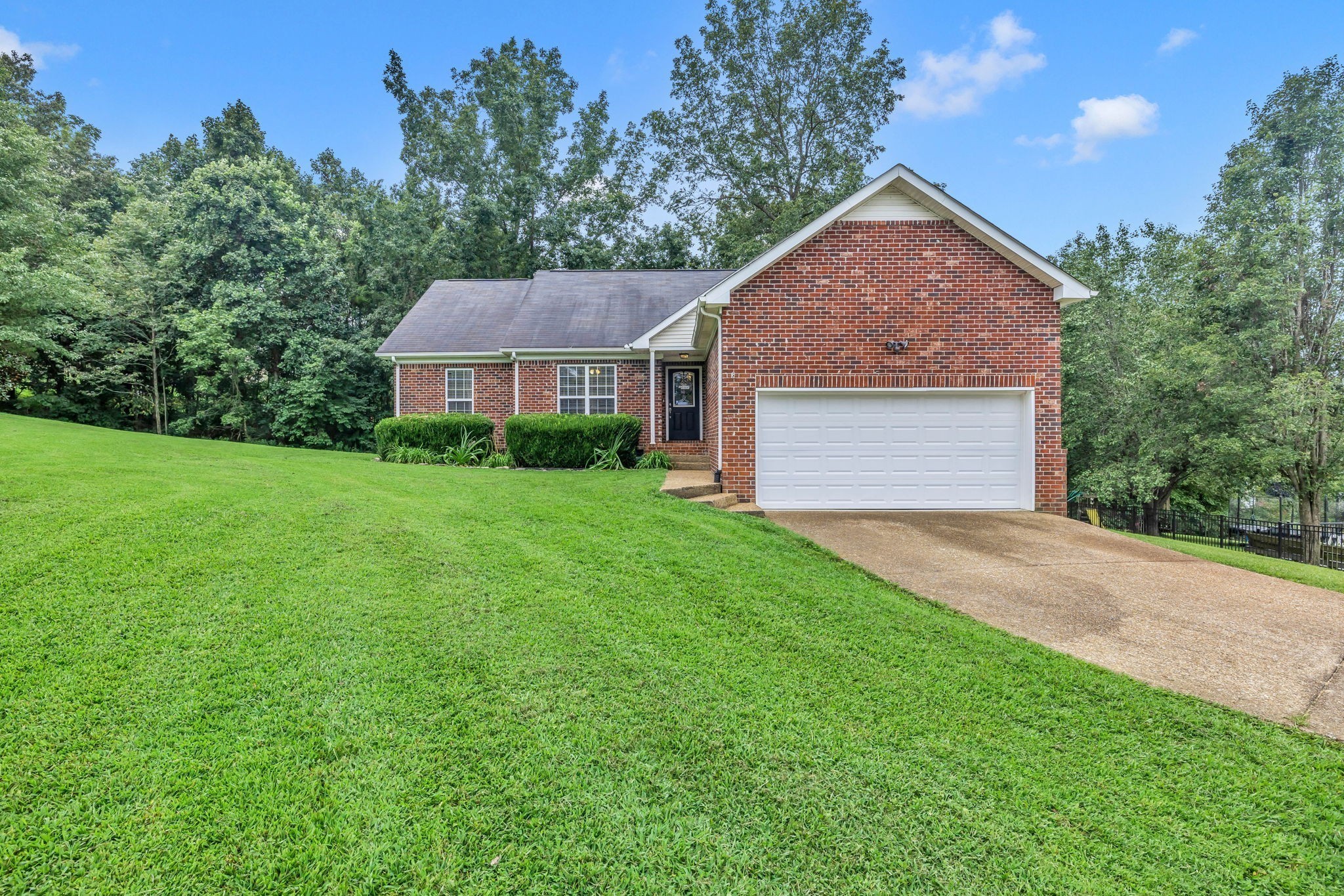 a view of a house with yard and tree s