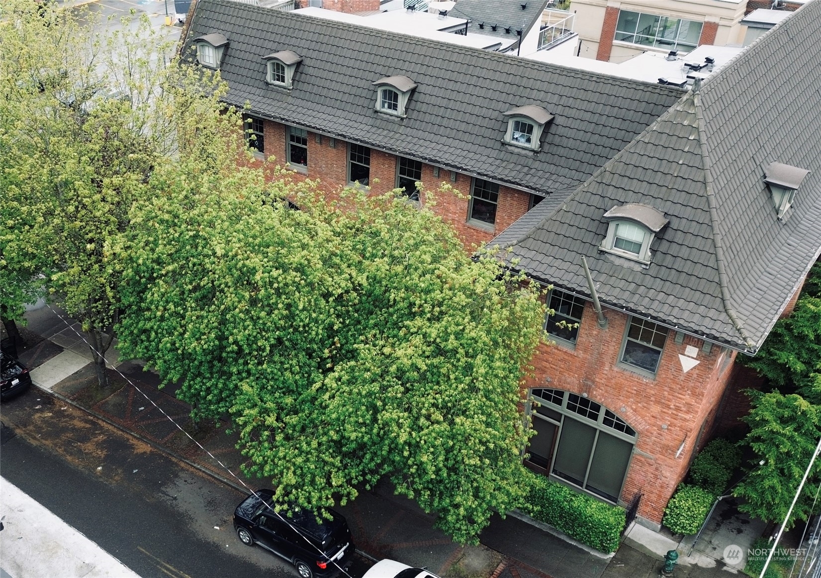 an aerial view of a house with a yard and potted plants