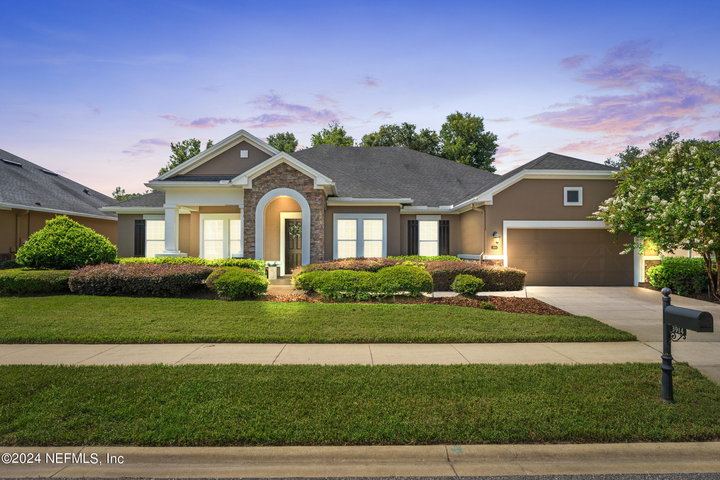 a front view of a house with a garden