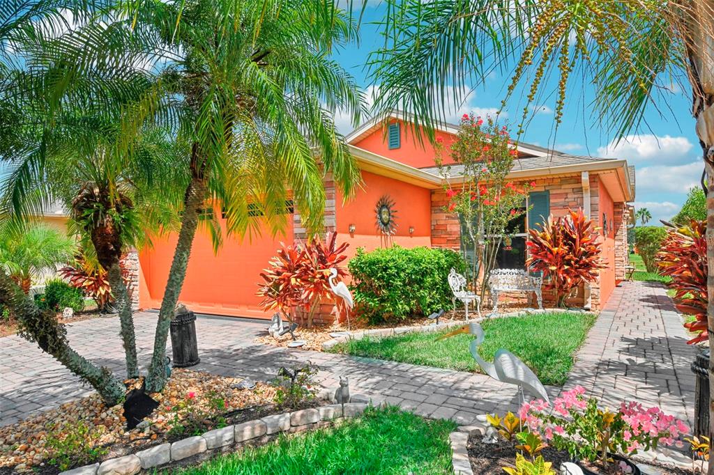 a front view of a house with a yard and potted plants