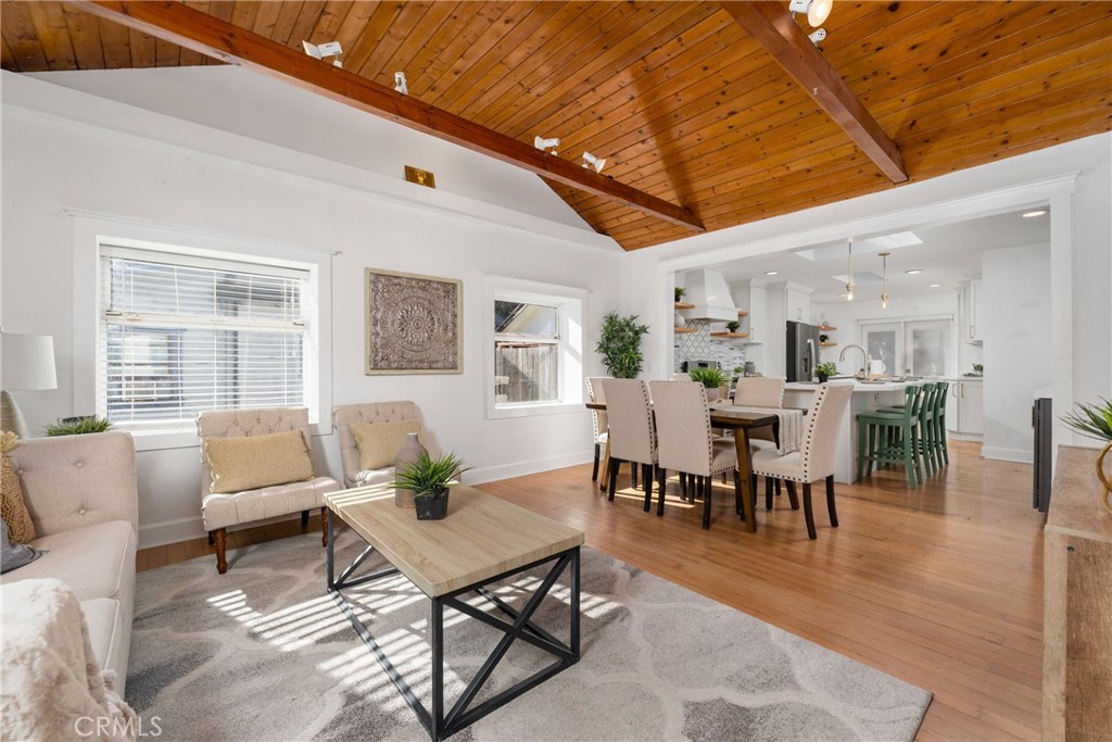 a living room with furniture wooden floor and a table