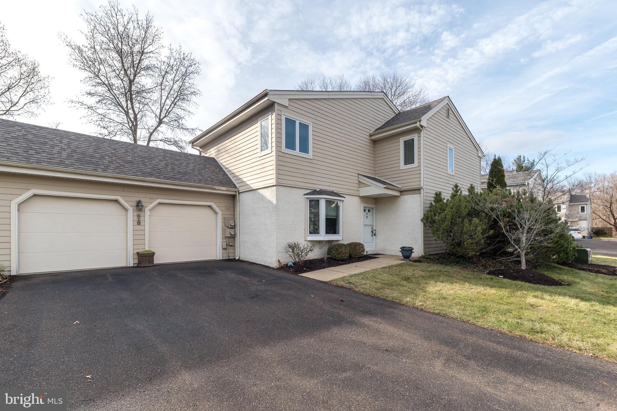 a view of a house with a yard and garage