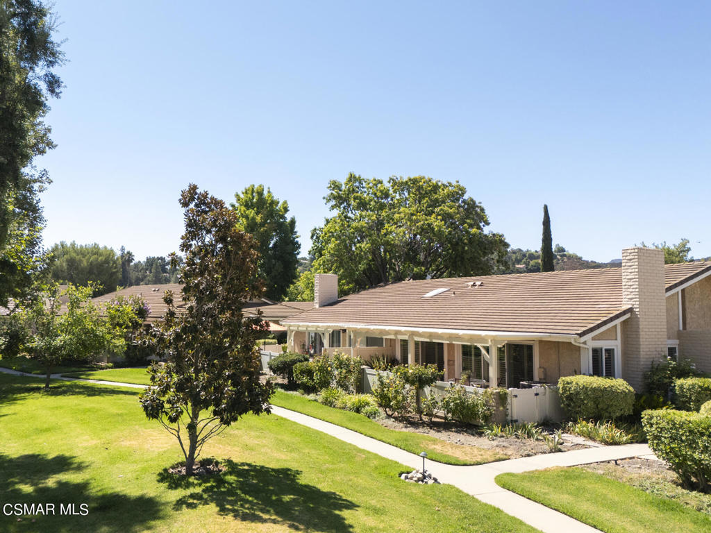 a view of a house with swimming pool and yard