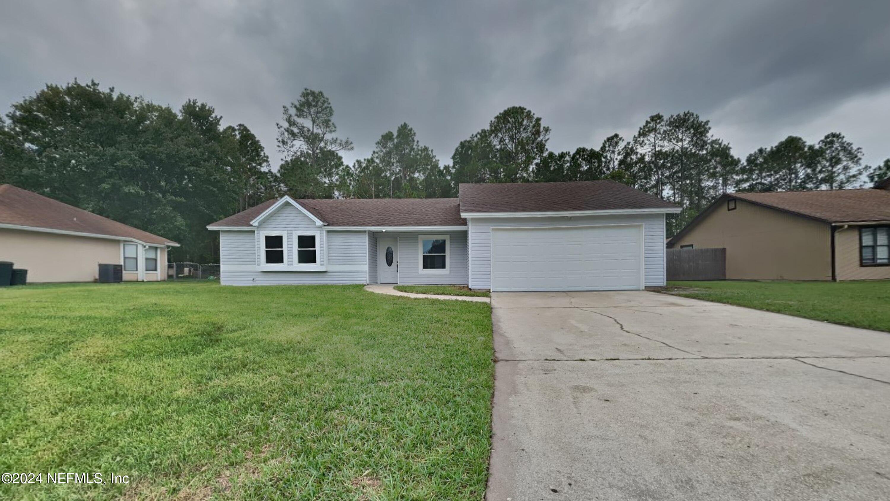 a front view of house with yard and green space