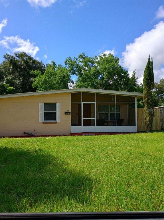 a view of house with backyard space and garden