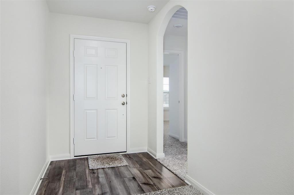 a view of a room with a sink and a mirror