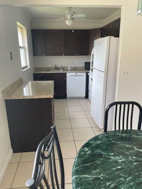 a kitchen with a sink a refrigerator and window