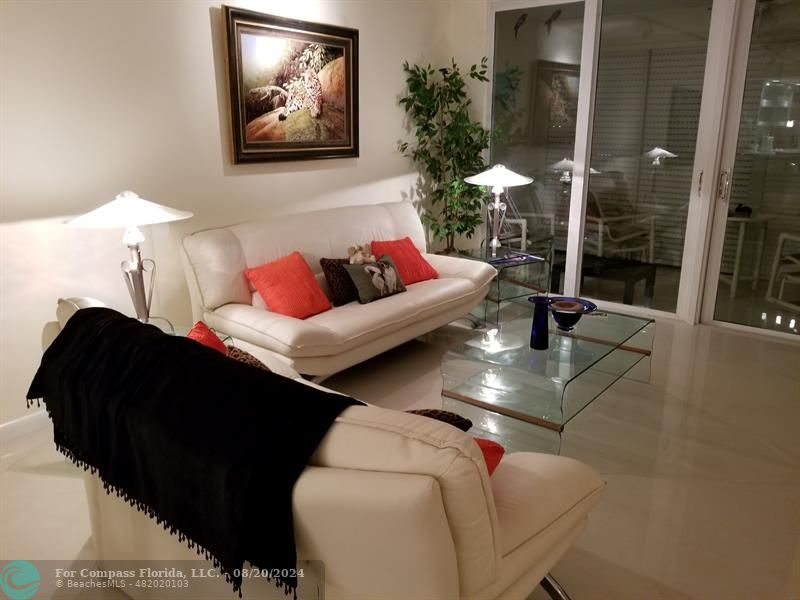 a living room with furniture and a potted plant