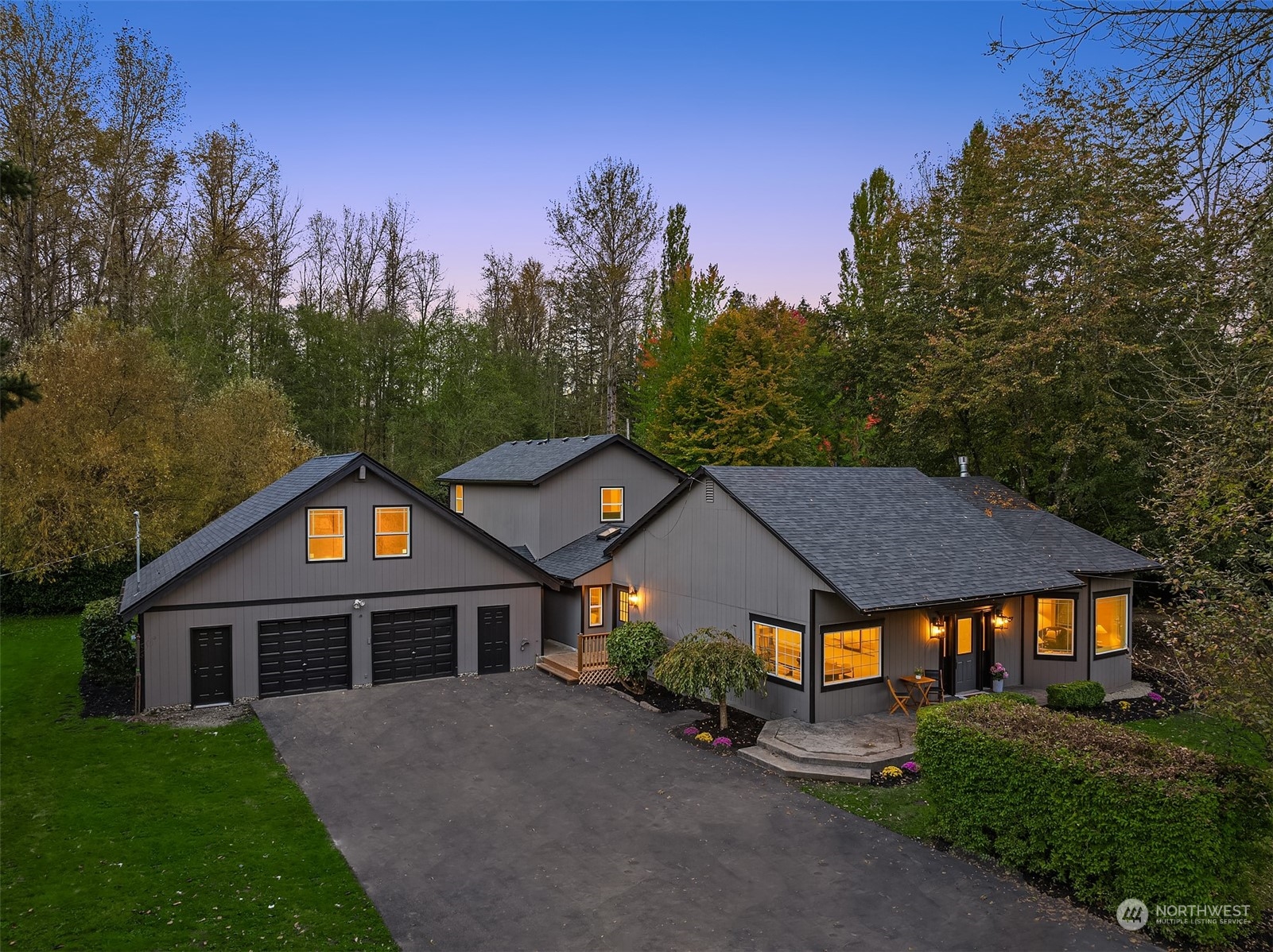 a front view of a house with yard and green space