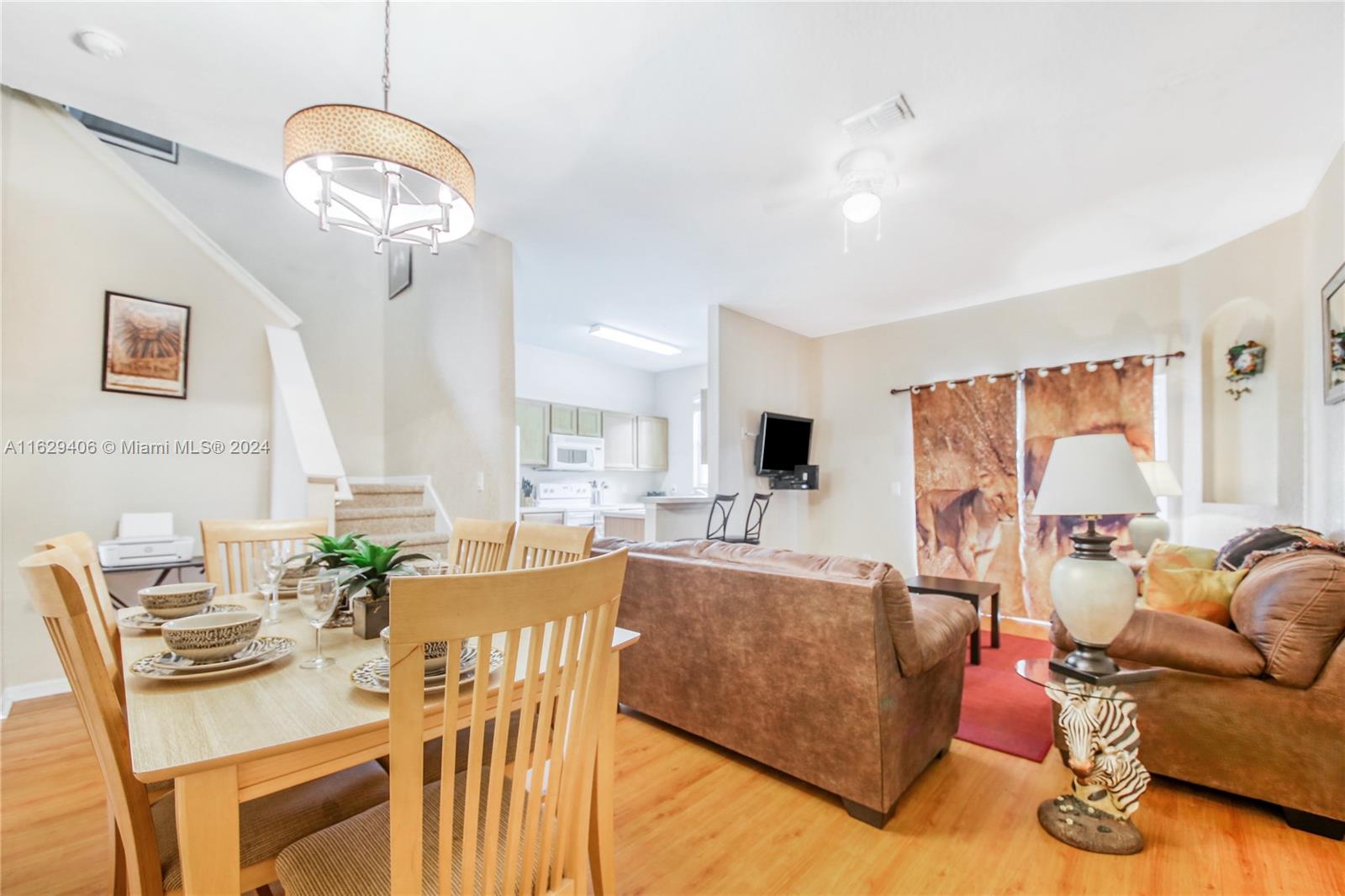 a living room with furniture a couch and wooden floor