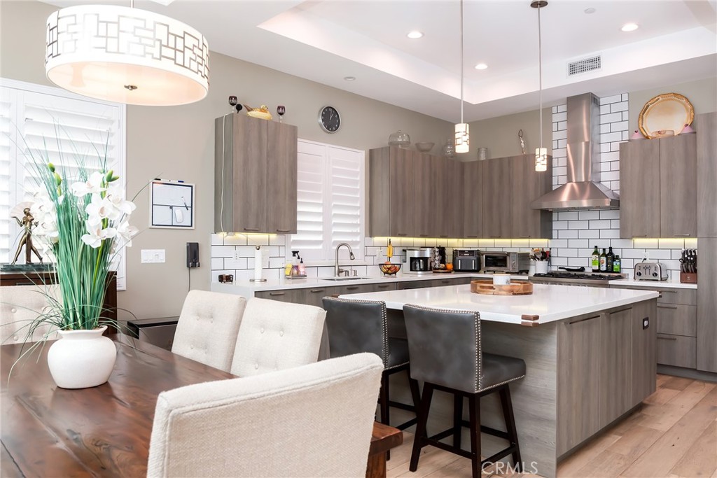 a kitchen with a sink stove and chairs