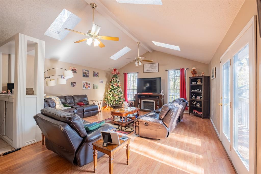 a living room with furniture a fireplace and a window