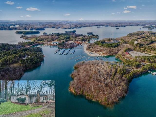 an aerial view of a house with a yard and lake view