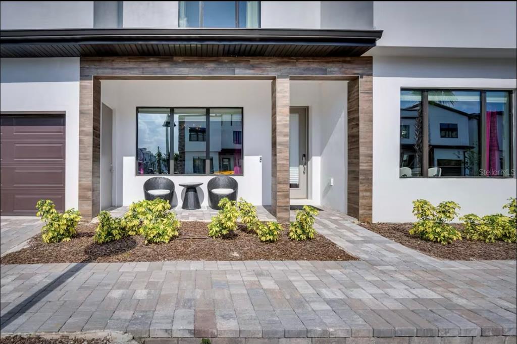 a view of a house with potted plants