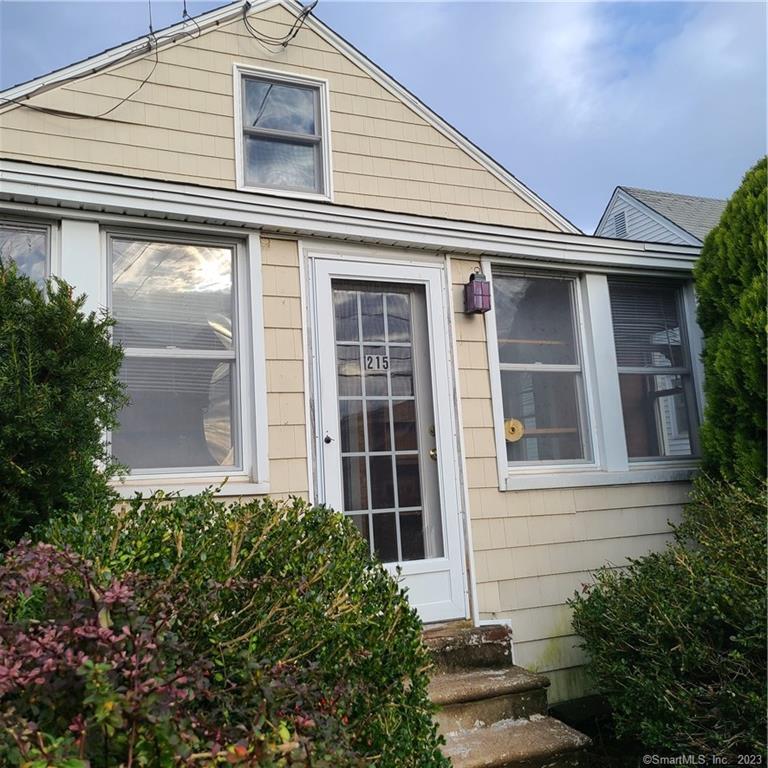 a view of a house with potted plants