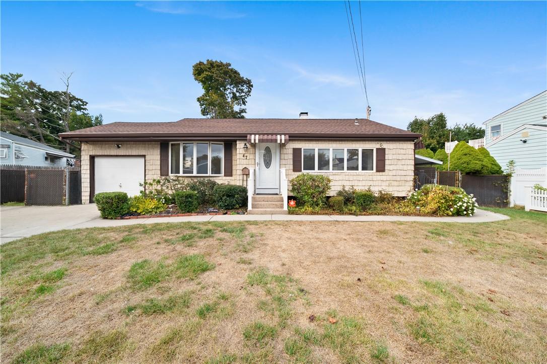 Single story home with a front lawn and a garage