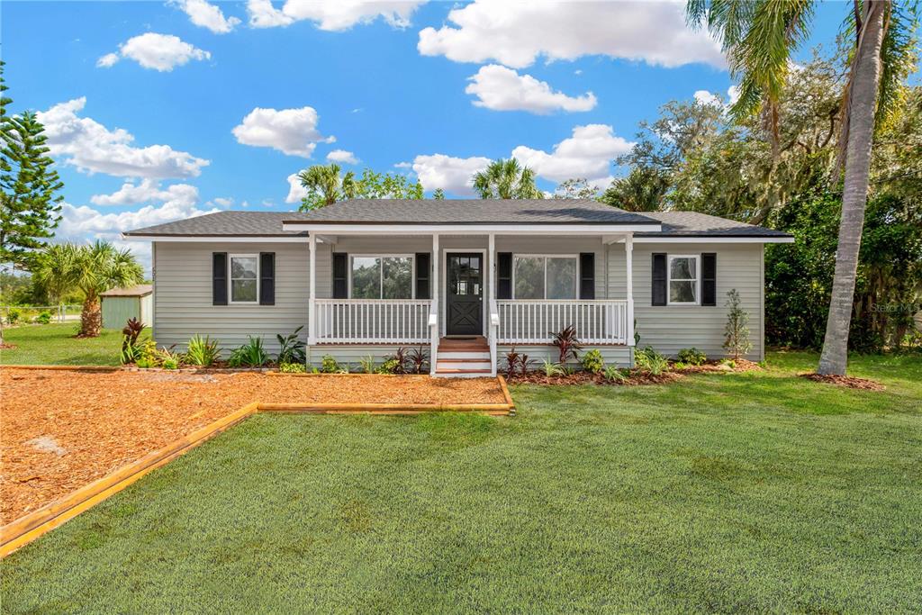 a front view of house with yard and seating area