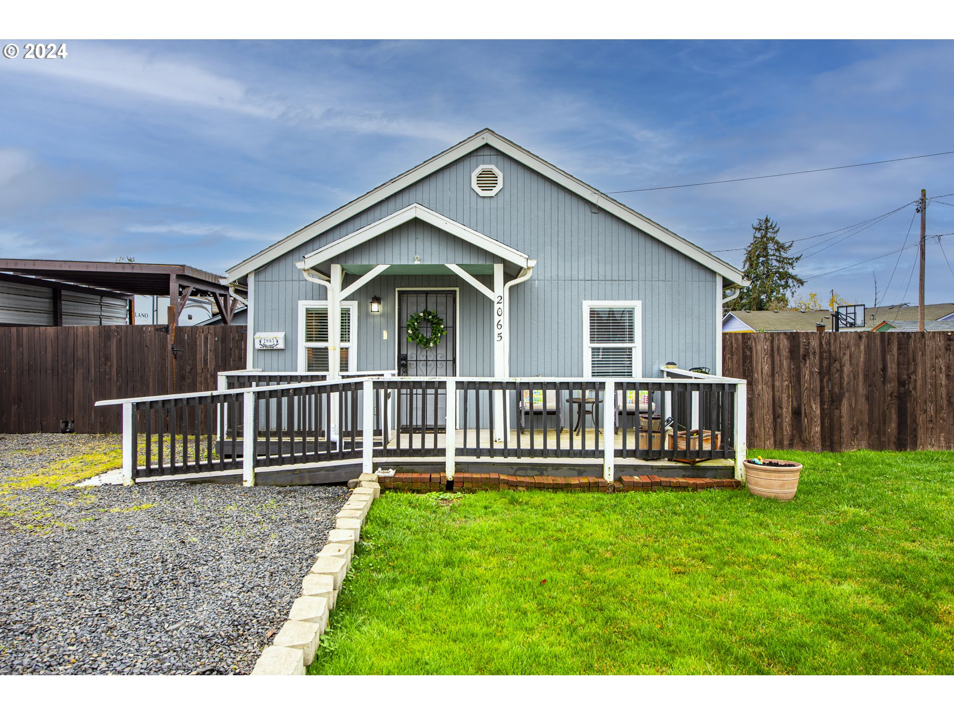 a front view of a house with a yard table and chairs