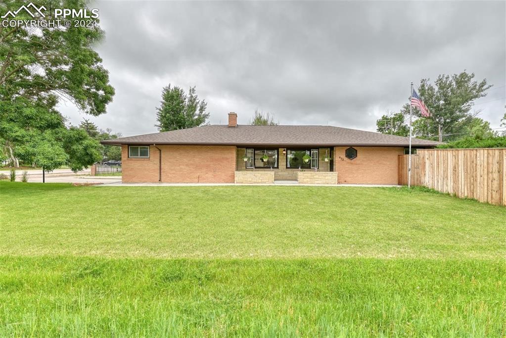 a front view of house with yard and trees