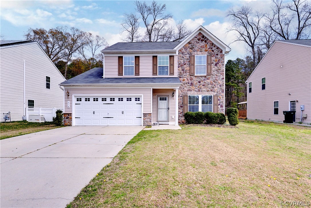 a front view of a house with a yard and garage