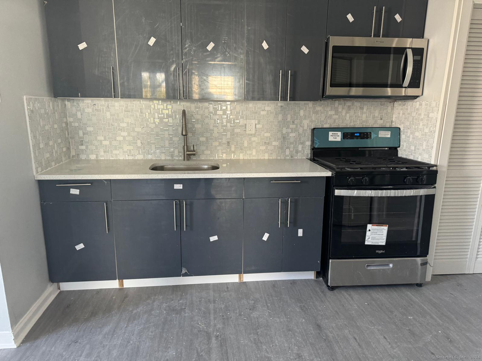 a kitchen with a sink and a stove