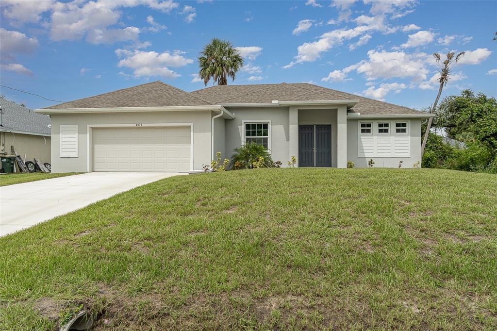 a front view of a house with a yard and garage