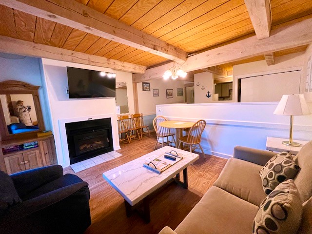 a living room with furniture a flat screen tv and a fireplace