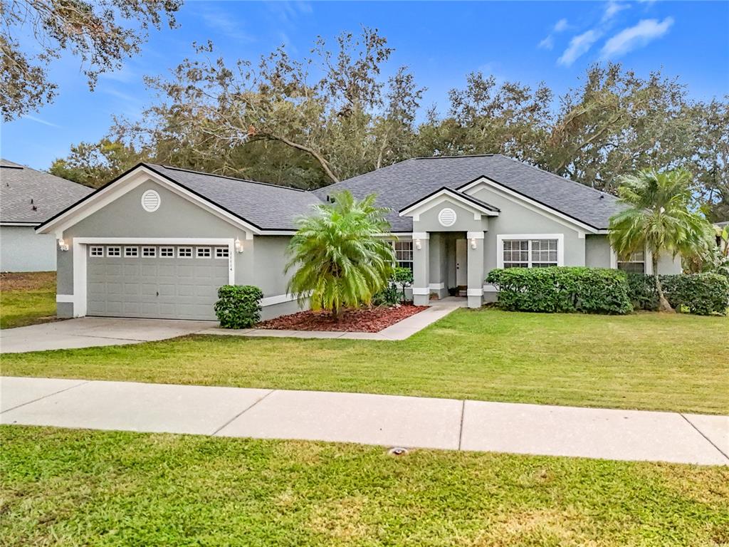 a front view of a house with a yard and garage