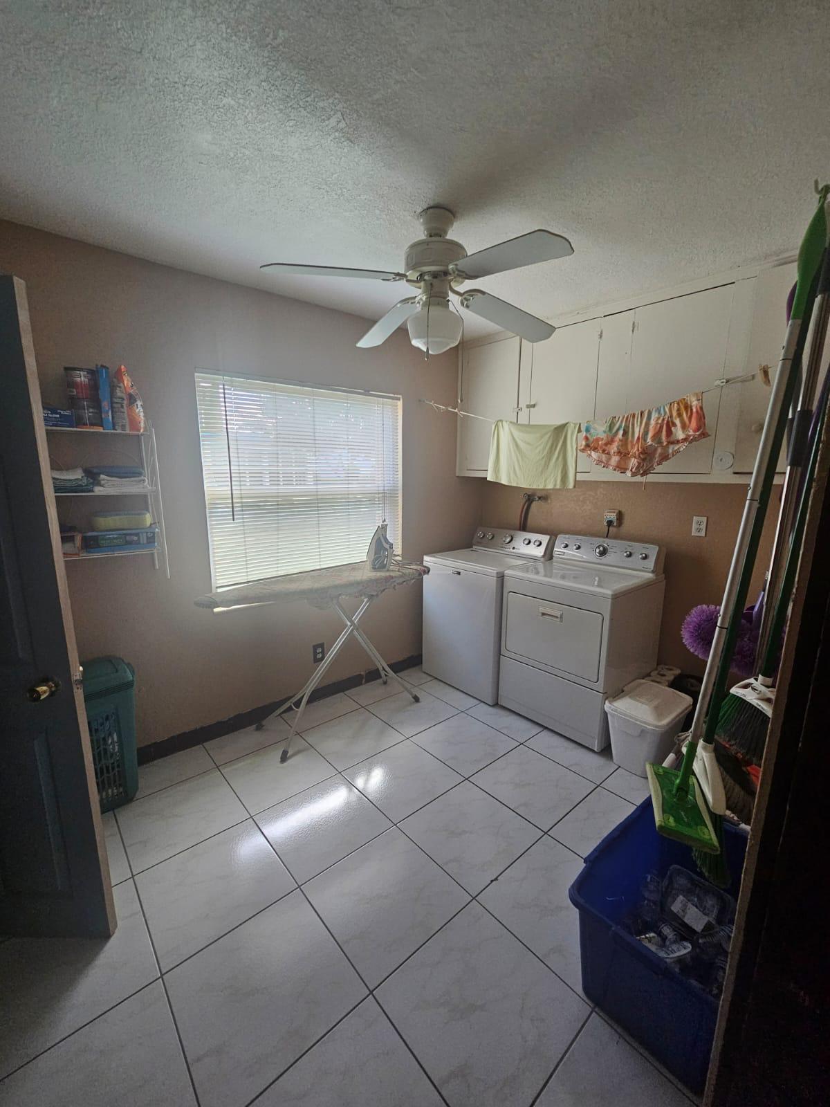 a kitchen with stainless steel appliances a sink a stove a refrigerator and a window