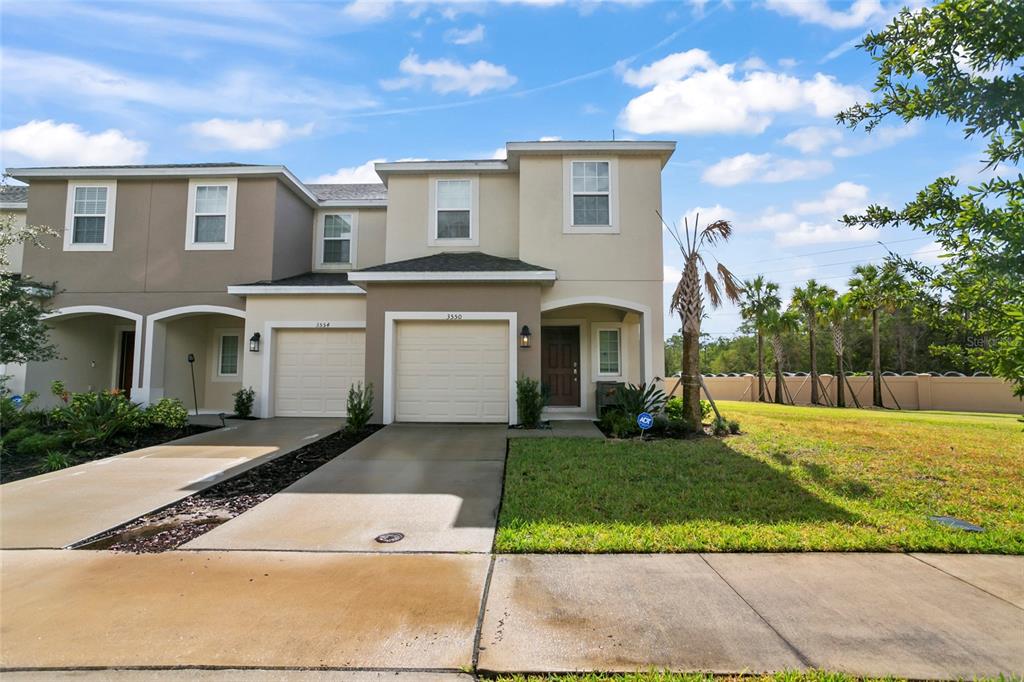 a front view of a house with a yard