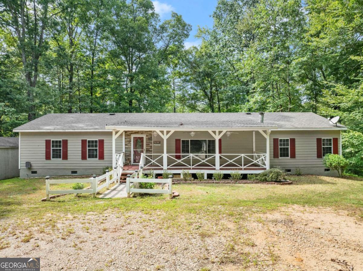 a front view of house with yard space and seating area